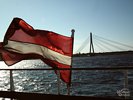 Latvian Flag and Vansu Bridge over the river Daugava in Riga - Latvia